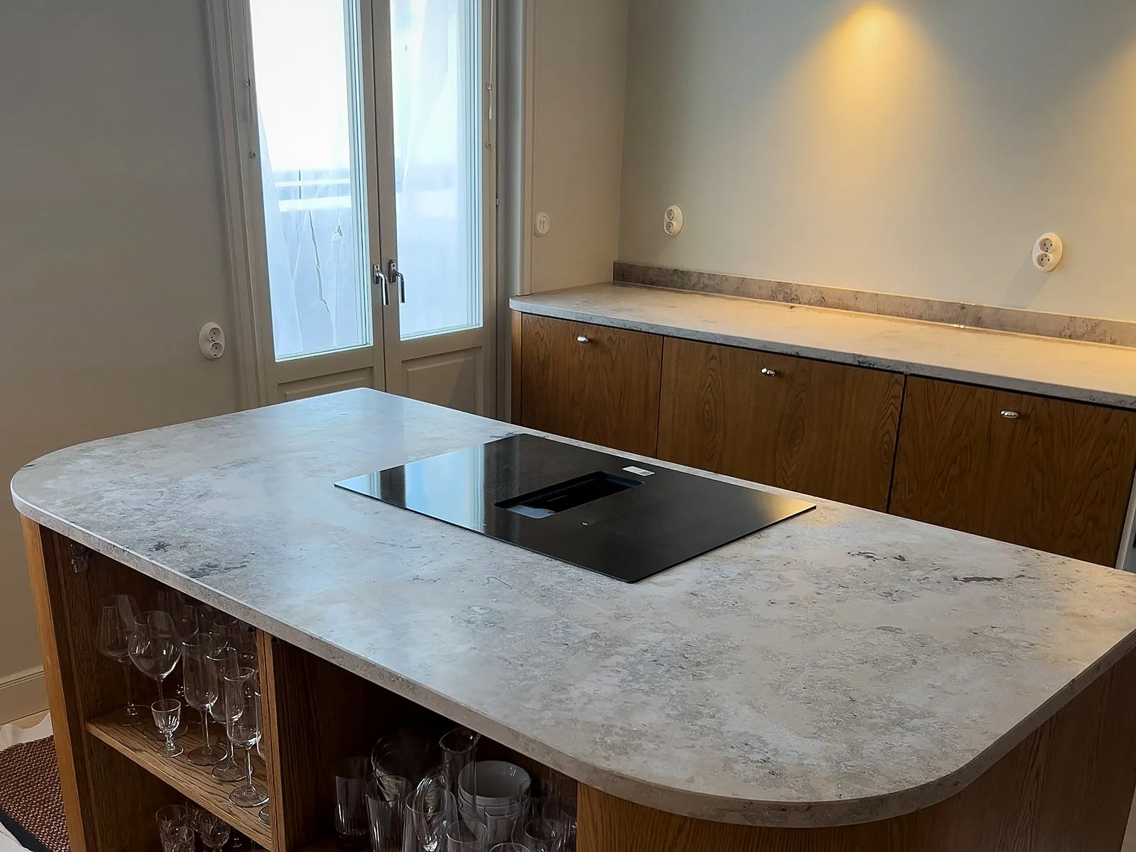 Rounded Jura Grey limestone kitchen island, installed by Stoneks