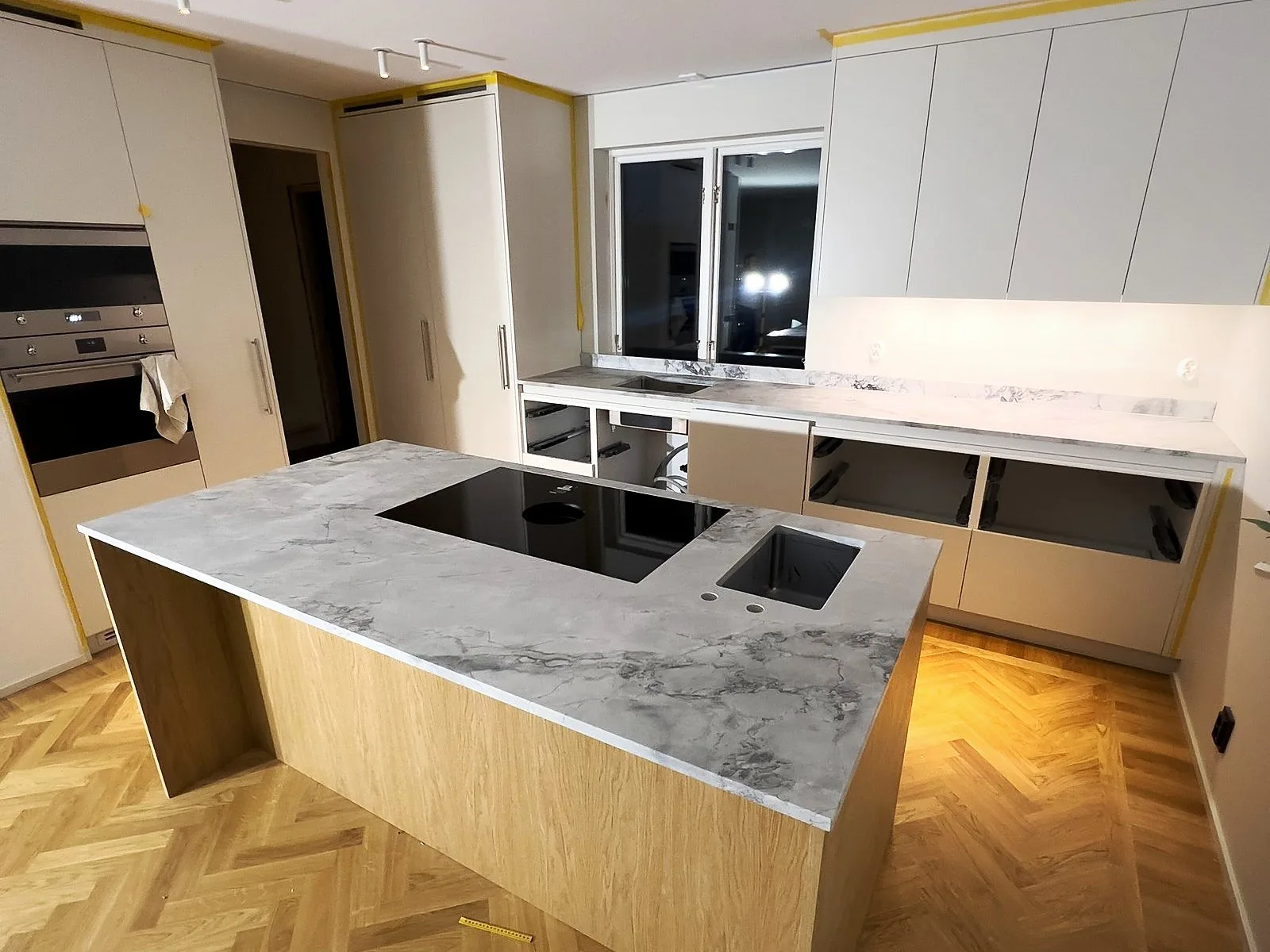 Super White quartzite kitchen island, installed by Stoneks