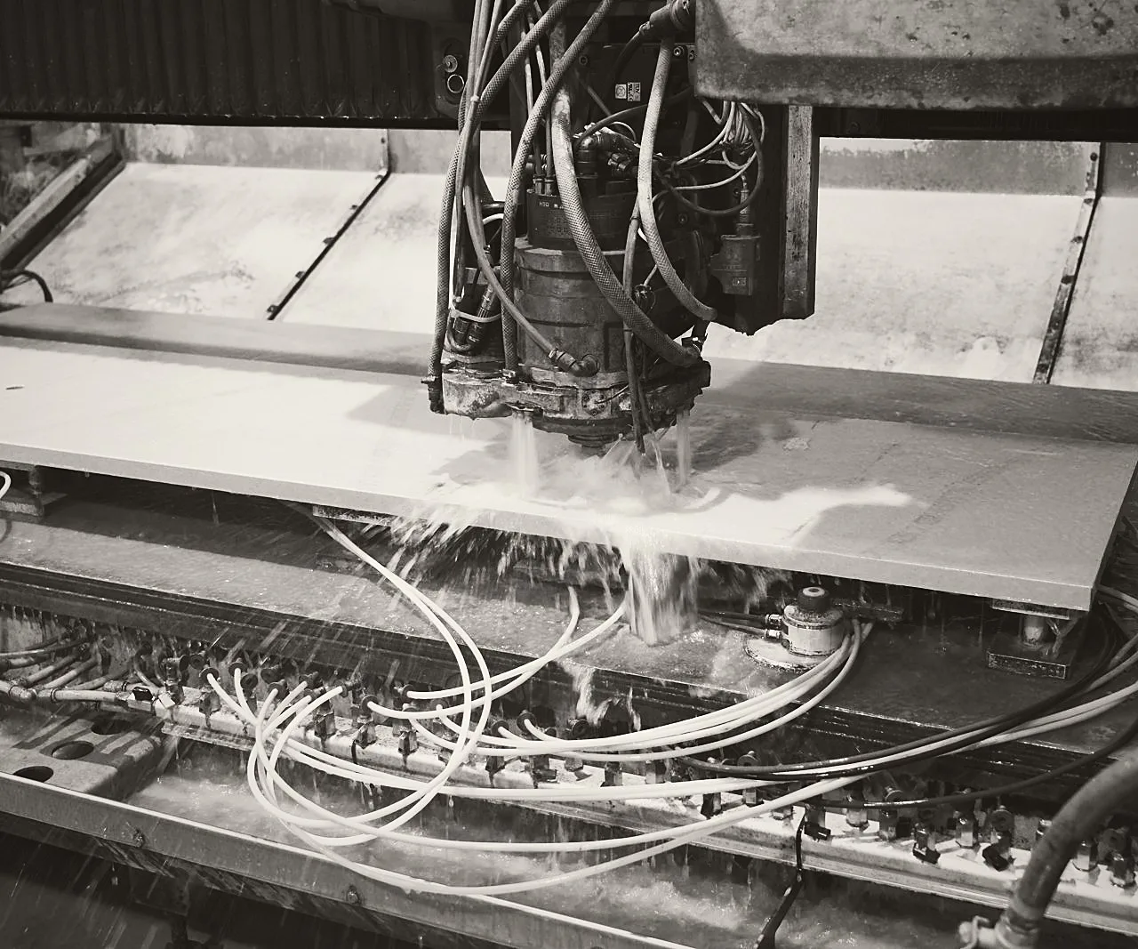 CNC machine working a stone slab at the Stoneks factory in Patika